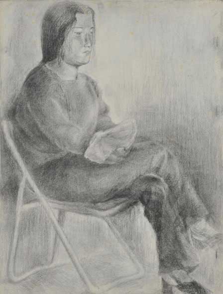 A woman holds an object.